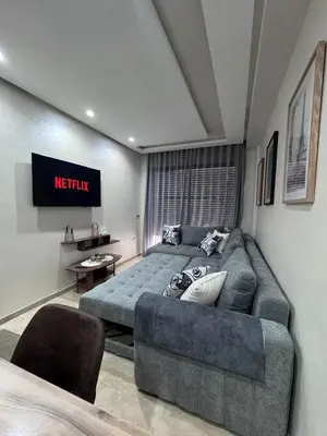 a living room with a couch and a television at Nova Casa in Casablanca