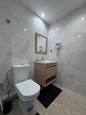 a white bathroom with a toilet and a sink at Nova Casa in Casablanca