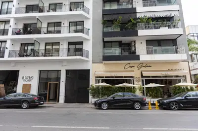 two cars parked in front of a building with umbrellas at Cosy Studio - Fitness access & Free Parking & Wifi Fiber in Casablanca