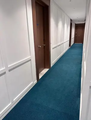 an empty hallway with a blue carpet and doors at Cosy Studio - Fitness access & Free Parking & Wifi Fiber in Casablanca