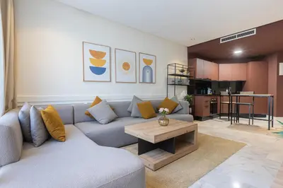 a living room with a couch and a table at Cosy Studio - Fitness access & Free Parking & Wifi Fiber in Casablanca