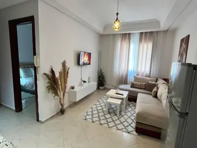 a living room with a couch and a mirror at La Parenthèse de CASABLANCA in Casablanca
