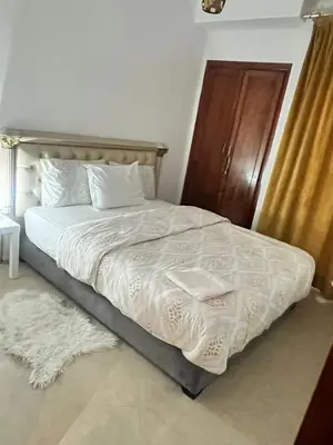 a bed with white sheets and pillows in a bedroom at La Parenthèse de CASABLANCA in Casablanca