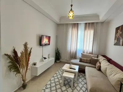 a living room with a couch and a table at La Parenthèse de CASABLANCA in Casablanca