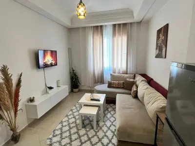 a living room with a couch and a table at La Parenthèse de CASABLANCA in Casablanca