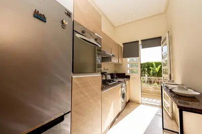 a kitchen with a stainless steel refrigerator and a sink at Welcome Sidi Rehal Escape King Bed Res Casabay in Sidi Rahal