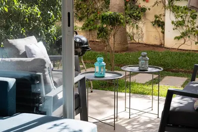 a patio with two tables next to a couch at Welcome Sidi Rehal Escape King Bed Res Casabay in Sidi Rahal