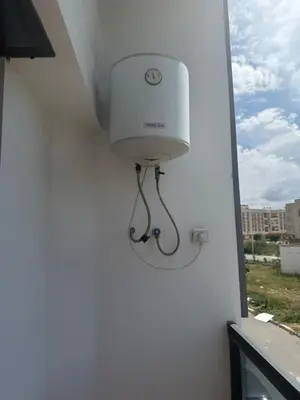 a white light on the side of a building at Comfortable and quiet apartment with Buzzinga in Bouznika