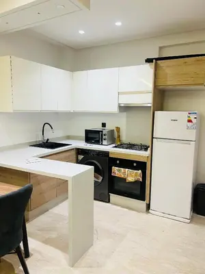 a kitchen with a white refrigerator and a stove at Rafina in Casablanca