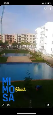 a picture of a swimming pool in front of a building at APPARTEMENT luxe in Mansouria
