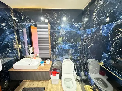 a bathroom with a toilet and a sink at Comfortable, quiet and beach apartment in Skhirat