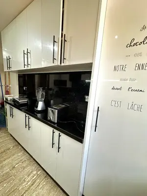 a kitchen with a refrigerator with writing on it at Comfortable, quiet and beach apartment in Skhirat