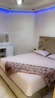 a bedroom with a large white bed in a room at Charming apartment in Mansoria in Mohammedia