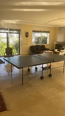 a ping pong table in the middle of a room at Villa à louer nouaceur 3 chambres in Nouaseur