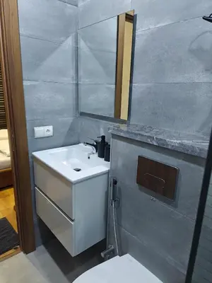 a bathroom with a white sink and a mirror at Casa Atlantica mit Meerblick und Poolparadies in Mansouria