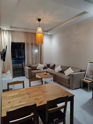 a living room with a couch and a table at Casa Atlantica mit Meerblick und Poolparadies in Mansouria
