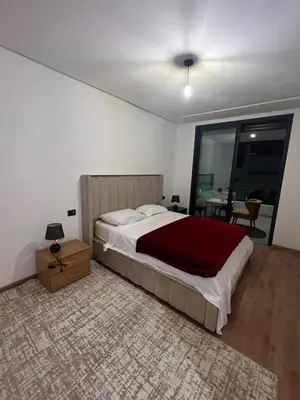a bedroom with a large bed and a table at Casablanca Finance City 33 Tower in Casablanca