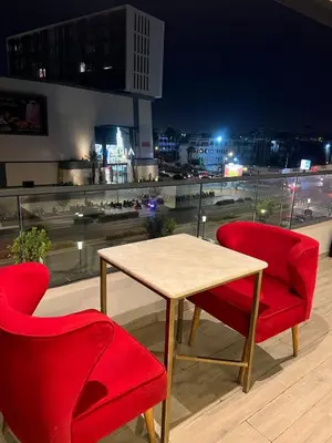 a table and two chairs on top of a building at Casablanca Finance City 33 Tower in Casablanca