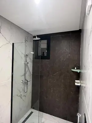 a bathroom with a shower with a glass door at Casablanca Finance City 33 Tower in Casablanca