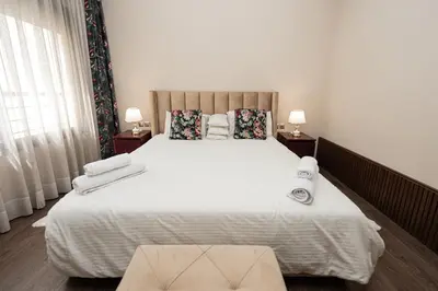 a bedroom with a large white bed with two lamps at Apartment Studio en Cœur de Casablanca ,Racine in Casablanca