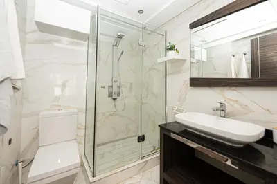 a bathroom with a glass shower and a sink at Apartment Studio en Cœur de Casablanca ,Racine in Casablanca