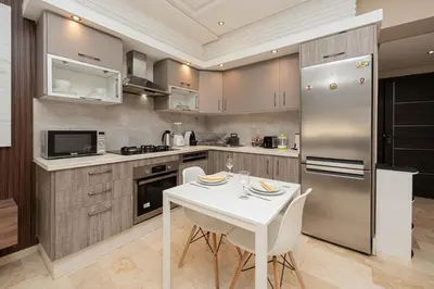 a kitchen with a white table and a refrigerator at Apartment Studio en Cœur de Casablanca ,Racine in Casablanca