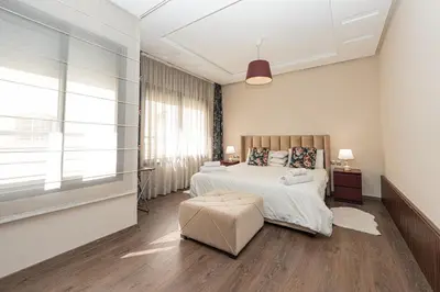 a bedroom with a bed and a large window at Apartment Studio en Cœur de Casablanca ,Racine in Casablanca