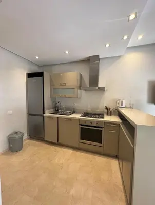 a kitchen with stainless steel appliances in a room at Urban flat Bourgogne in Casablanca