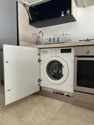 a kitchen with a washing machine in a kitchen at Urban flat Bourgogne in Casablanca