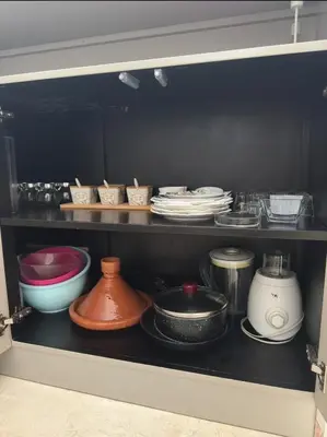 a shelf with plates and bowls and other dishes at Urban flat Bourgogne in Casablanca