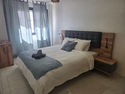a bedroom with a large bed with a head board at Tounarouz Studio in Casablanca