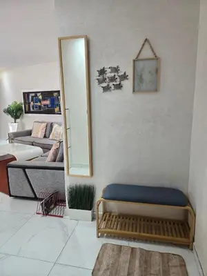 a mirror and a bench in a living room at Tounarouz Studio in Casablanca