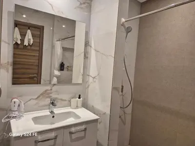 a bathroom with a sink and a shower at aeroperla 11 aeroprt casa blanca in Nouaseur