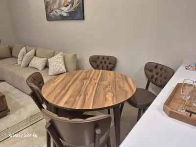 a wooden table in a living room with a couch at aeroperla 11 aeroprt casa blanca in Nouaseur