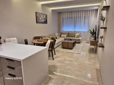a living room with a couch and a table at aeroperla 11 aeroprt casa blanca in Nouaseur