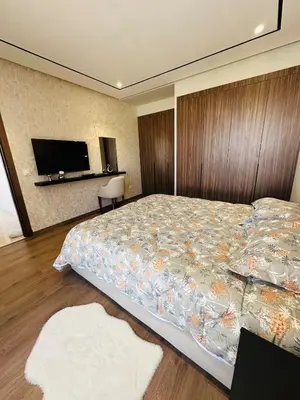 a bedroom with a bed and a tv on the wall at Studio Adam 18 CFC 2 minutes away in Casablanca
