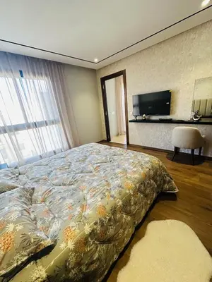 a bedroom with a bed and a tv on the wall at Studio Adam 18 CFC 2 minutes away in Casablanca