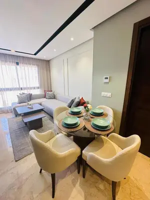 a living room with a table and chairs at Studio Adam 18 CFC 2 minutes away in Casablanca