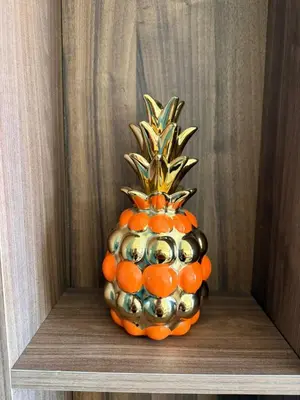 a pineapple decoration is sitting on a shelf at Studio Al Mahdi 23 CFC 2 minutes away in Casablanca