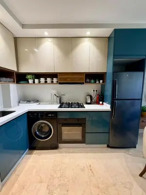 a kitchen with blue cabinets and a washer at Studio Al Mahdi 23 CFC 2 minutes away in Casablanca