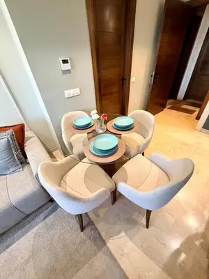 a table and chairs in a living room at Studio Al Mahdi 23 CFC 2 minutes away in Casablanca
