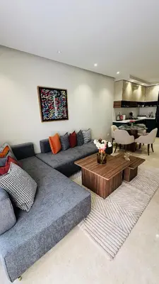 a living room with a couch and a table at Studio Iza 08 CFC à 2mn in Casablanca