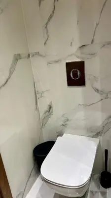 a bathroom with a white toilet and a marble wall at Studio le César 6 CFC 2 minutes away in Casablanca