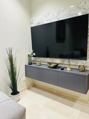 a living room with a large television on a wall at Studio le César 6 CFC 2 minutes away in Casablanca