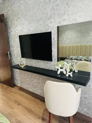 a living room with a tv and a white chair at Studio New York 1 CFC 2 minutes away in Casablanca