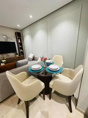 a living room with a table and chairs at Studio New York 1 CFC 2 minutes away in Casablanca