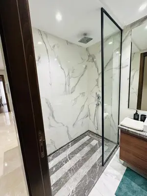 a bathroom with a marble shower with a glass door at Studio New York 1 CFC 2 minutes away in Casablanca