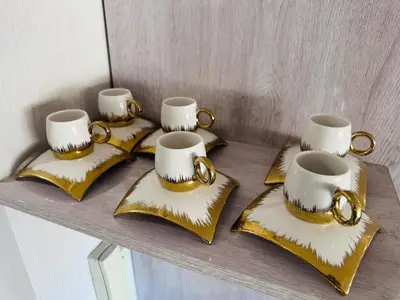 a group of four tea sets on gold star napkins at Melrose Sea View, Pool & Garden in Tamaris