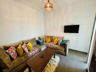 a living room with a couch and a coffee table at Janat KLK, tamaris beach in Tamaris