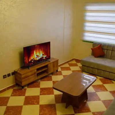 a living room with a couch and a fireplace at tanger in Aïn Diab